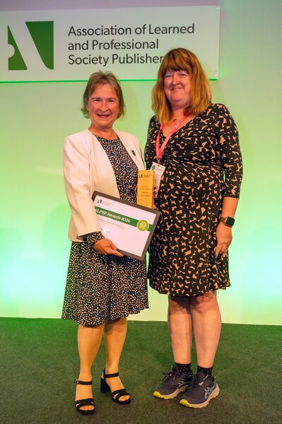 Photo of Claire Moulton accepting award